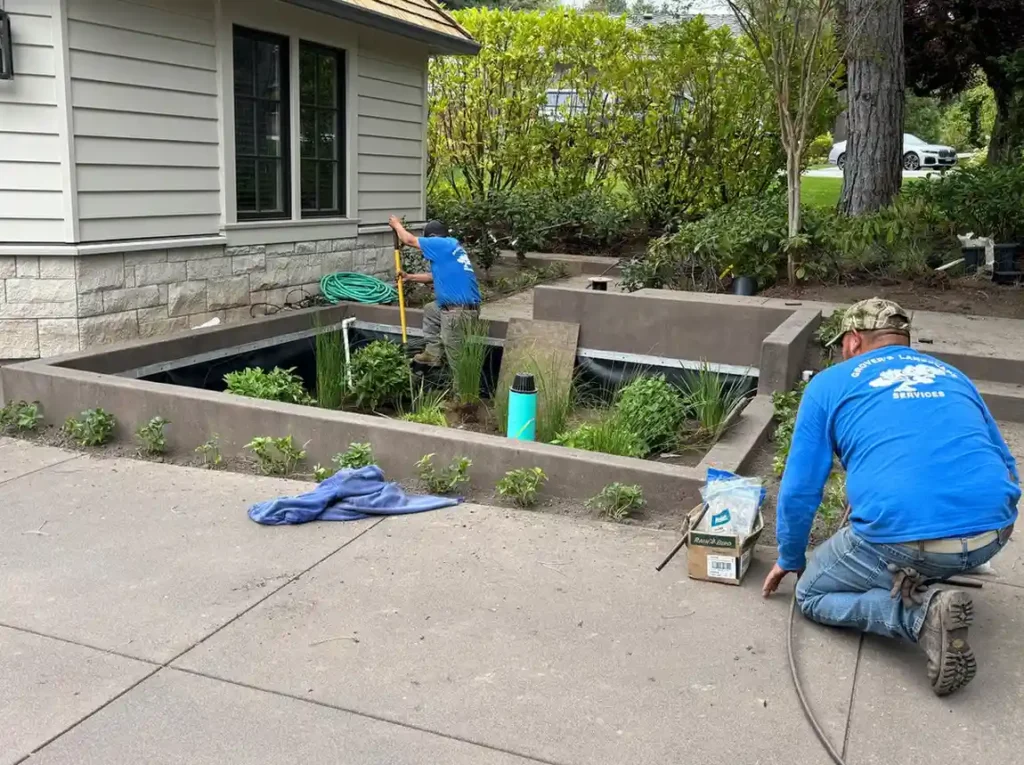 ater feature installation with naturalistic pond and waterfall in Oregon landscape